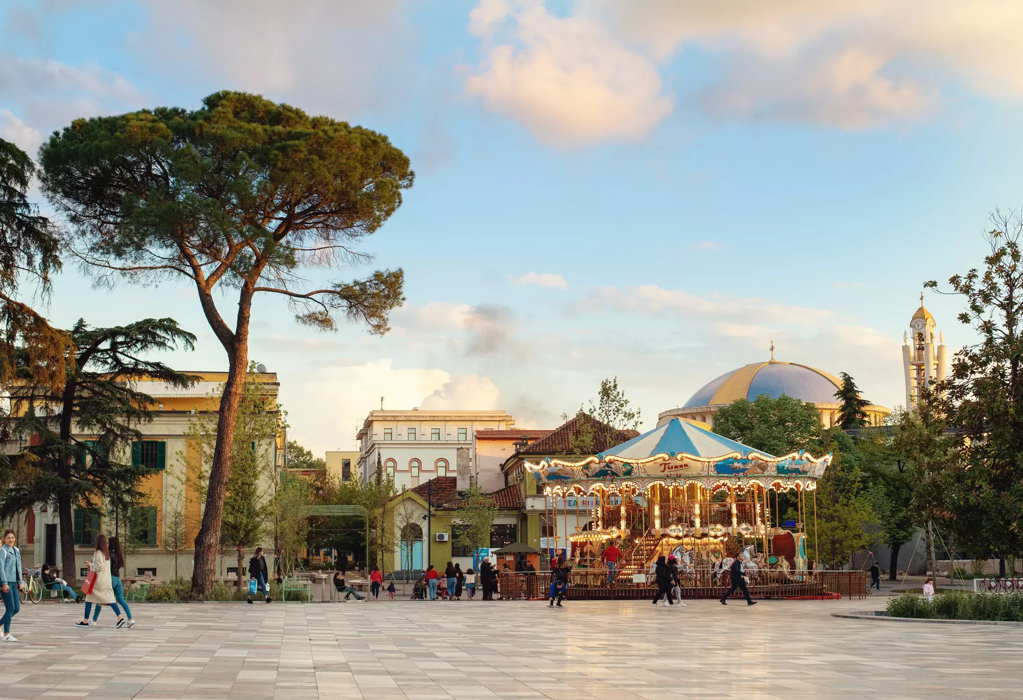 A carousel in a square in Albania at dusk.