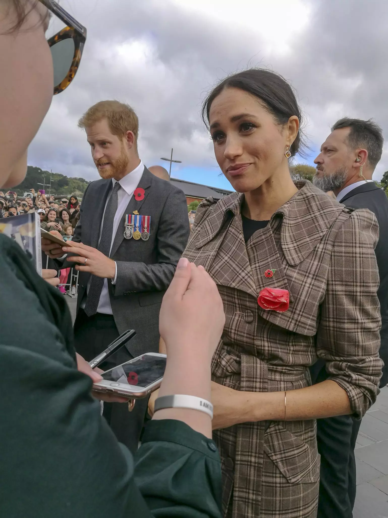 Prince Harry and Meghan Markle olds hands while visiting a Youth Employment Service building in South Africa.