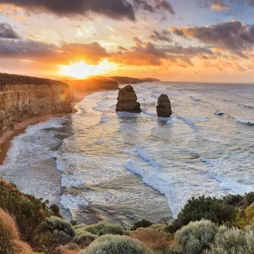 Two of Twelve Apostles rock formations in sea, Great Ocean Road at sunset