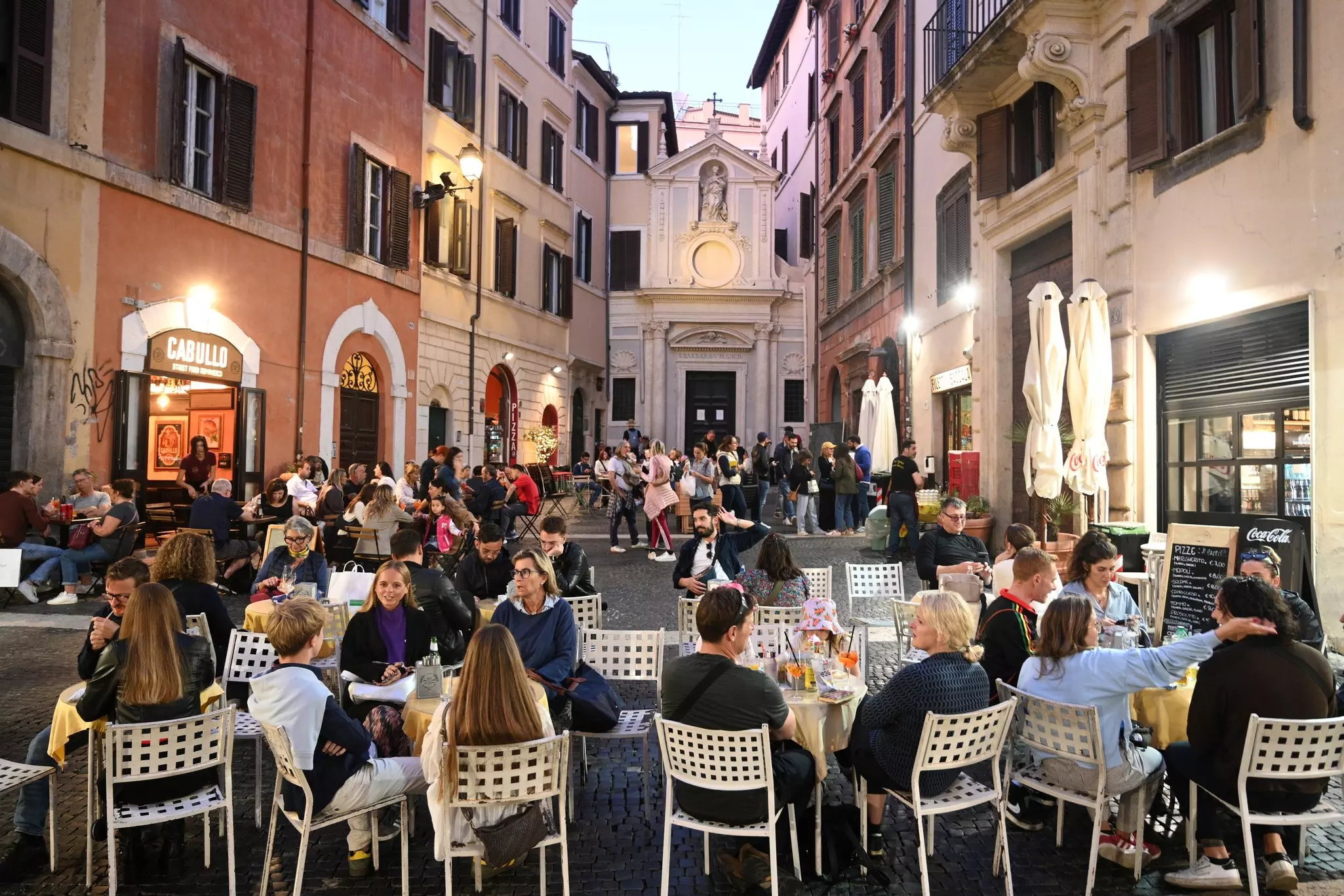 People relax in a cafe in the center of Rome.
