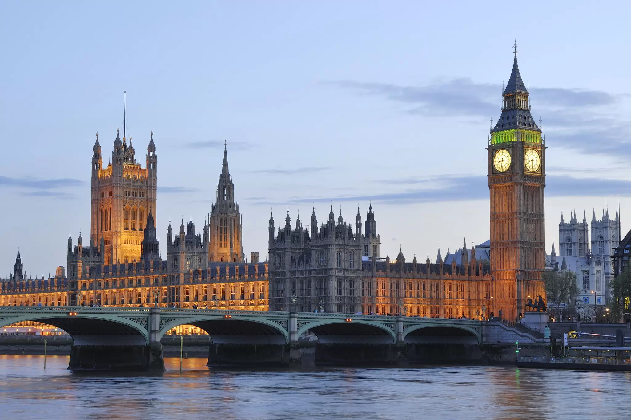 Long-exposure night photo of the Houses of Parliament (Palace of Westminster), a large Neo-Gothic building on the River Thames