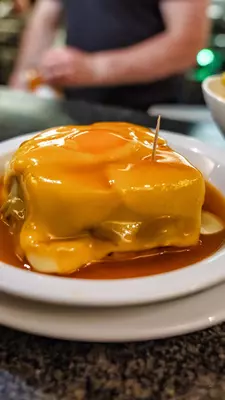 A sandwich covered in melted cheese sitting in a 