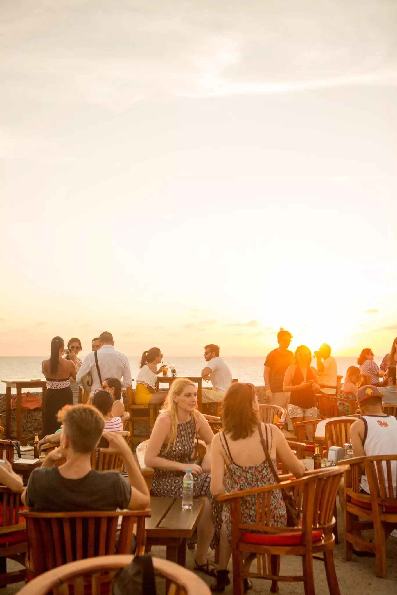 Patrons watch the sunset from the sea wall in the Old Town neighborhood in Cartagena, Colombia.