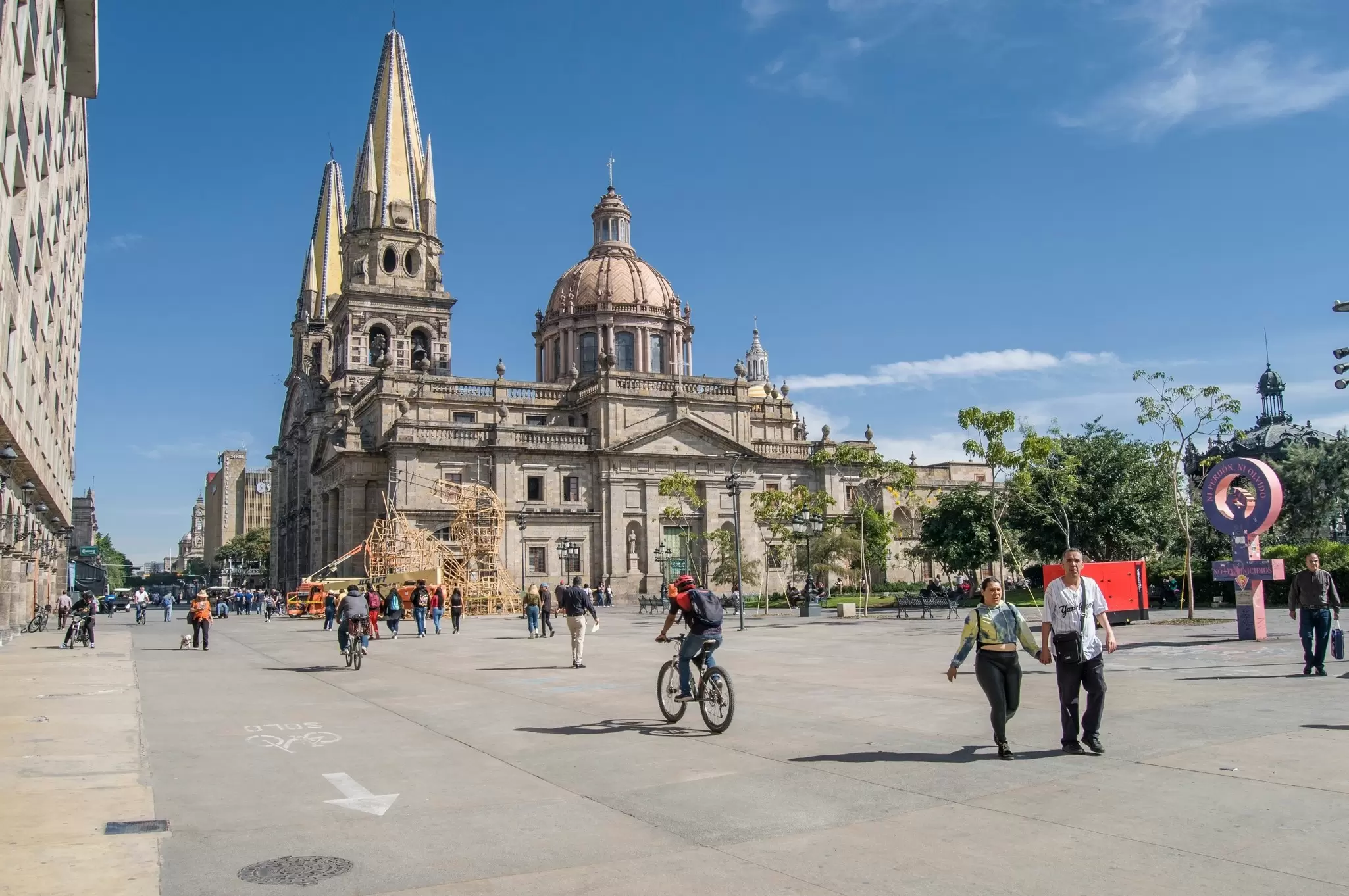 People walking on the main square near the Cathedral on a sunny day to enjoy holiday in Guadalajara jalisco Mexico. 