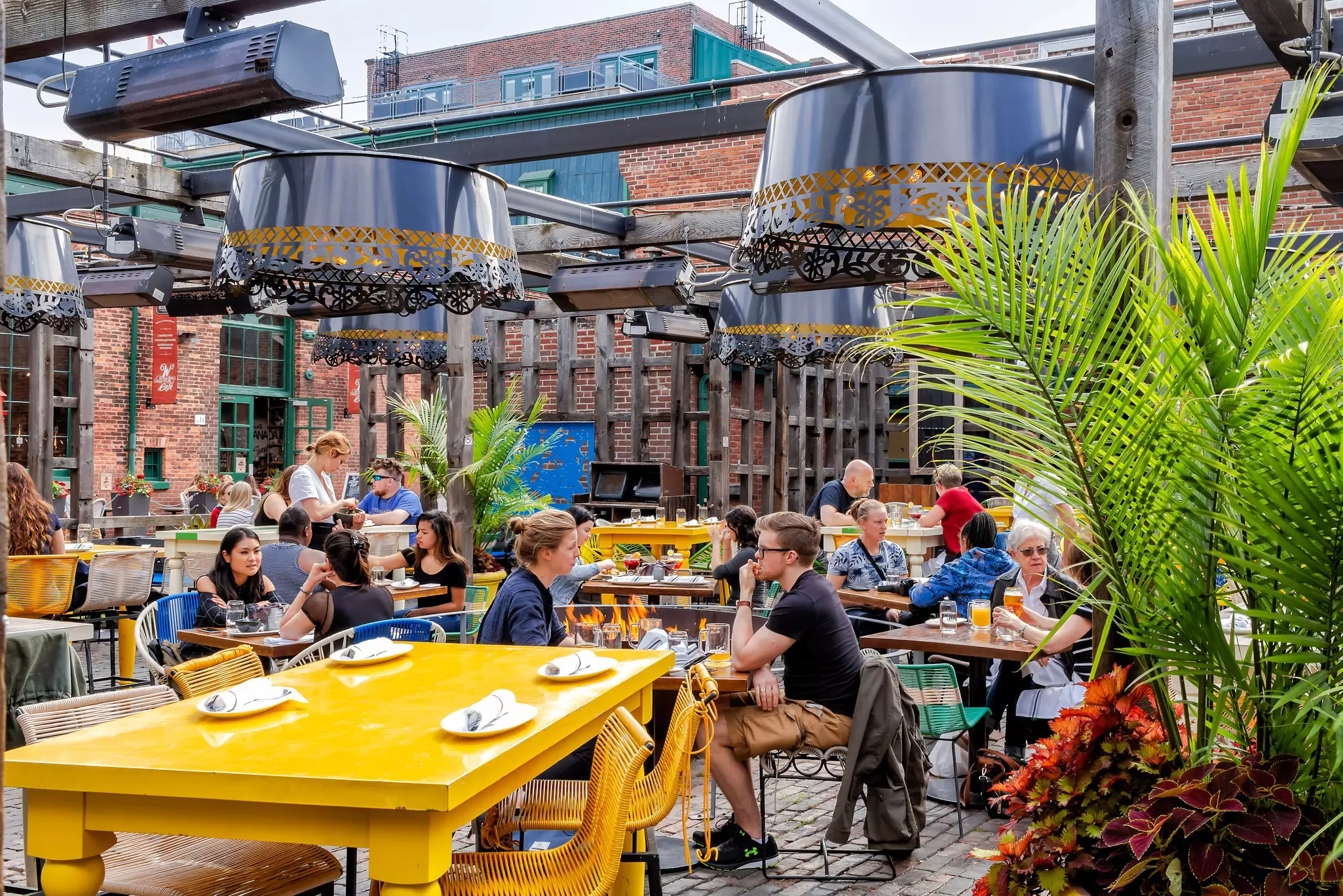 Visitors drinking at an outdoor bar in the Distillery District, Toronto