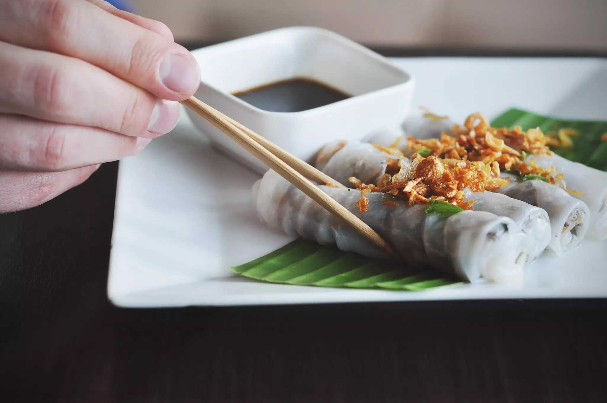 close up of shrimp and sausage gumbo in a cast-iron pot on a wooden table