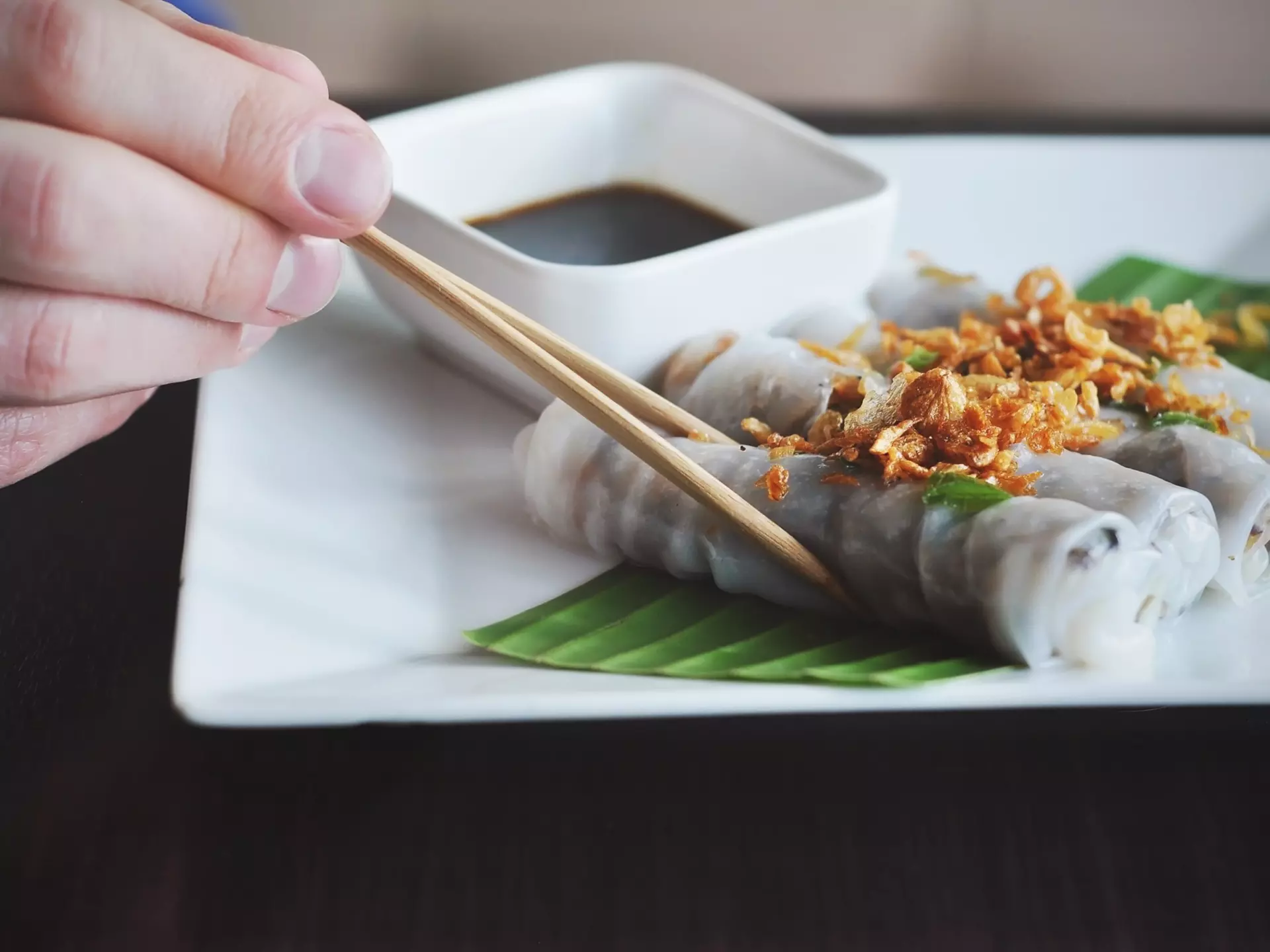 close up of shrimp and sausage gumbo in a cast-iron pot on a wooden table