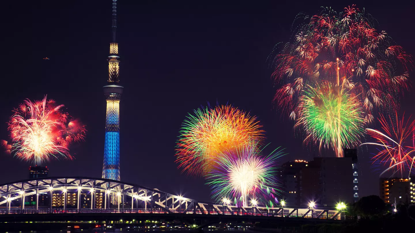 Summer fireworks over the Sumida river at night in Tokyo, Japan