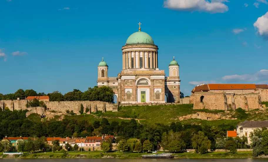 Esztergom Basilica with its green dome on Castle Hill above the Danube, with the castle walls and riverside houses below