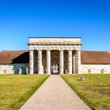 Arc-et-Senans, France - September 1, 2020: Front view of the southern facade of the former Guards building of the Royal Saltworks, with a neoclassical portico, only entrance to the site.