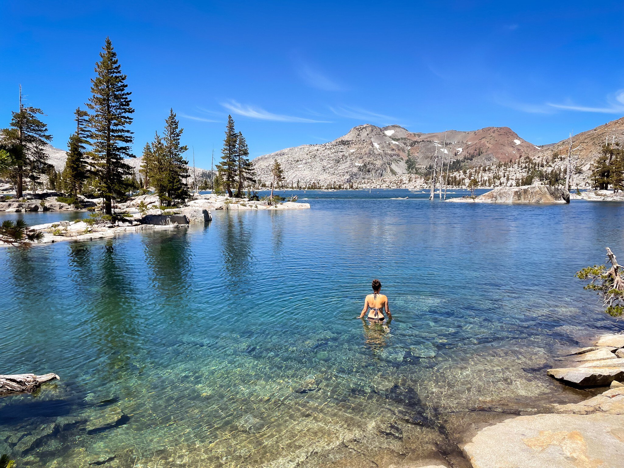 A woman swims in Lake Aloha in the Desolation Wilderness, Lake Tahoe, California.