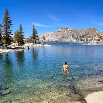 A woman swims in Lake Aloha in the Desolation Wilderness, Lake Tahoe, California.