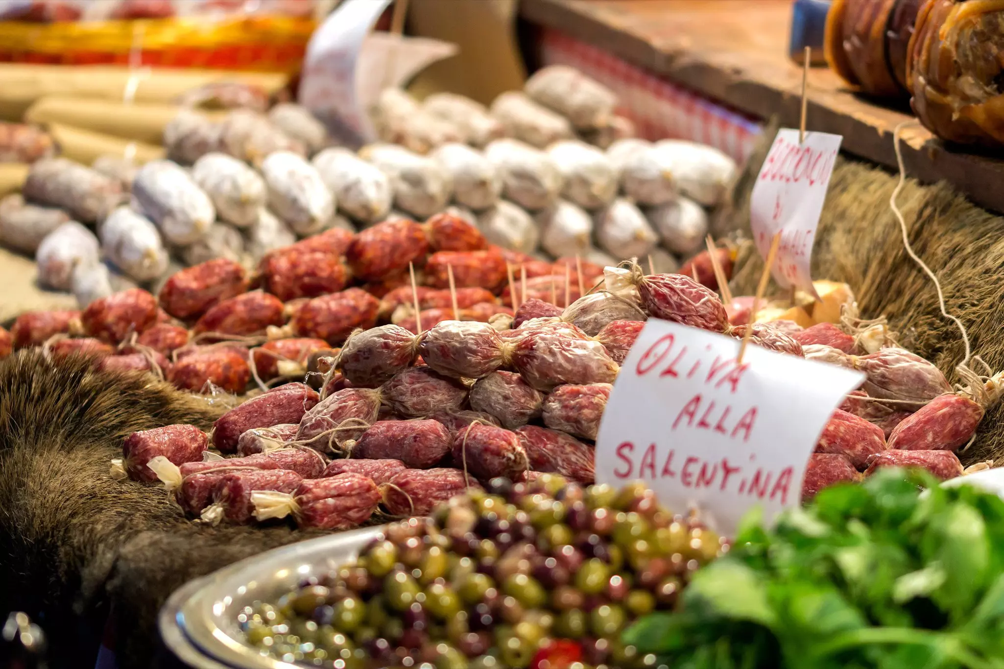The people of Umbria love to celebrate their local culinary specialties, like wild boar salami and olives © Getty Images