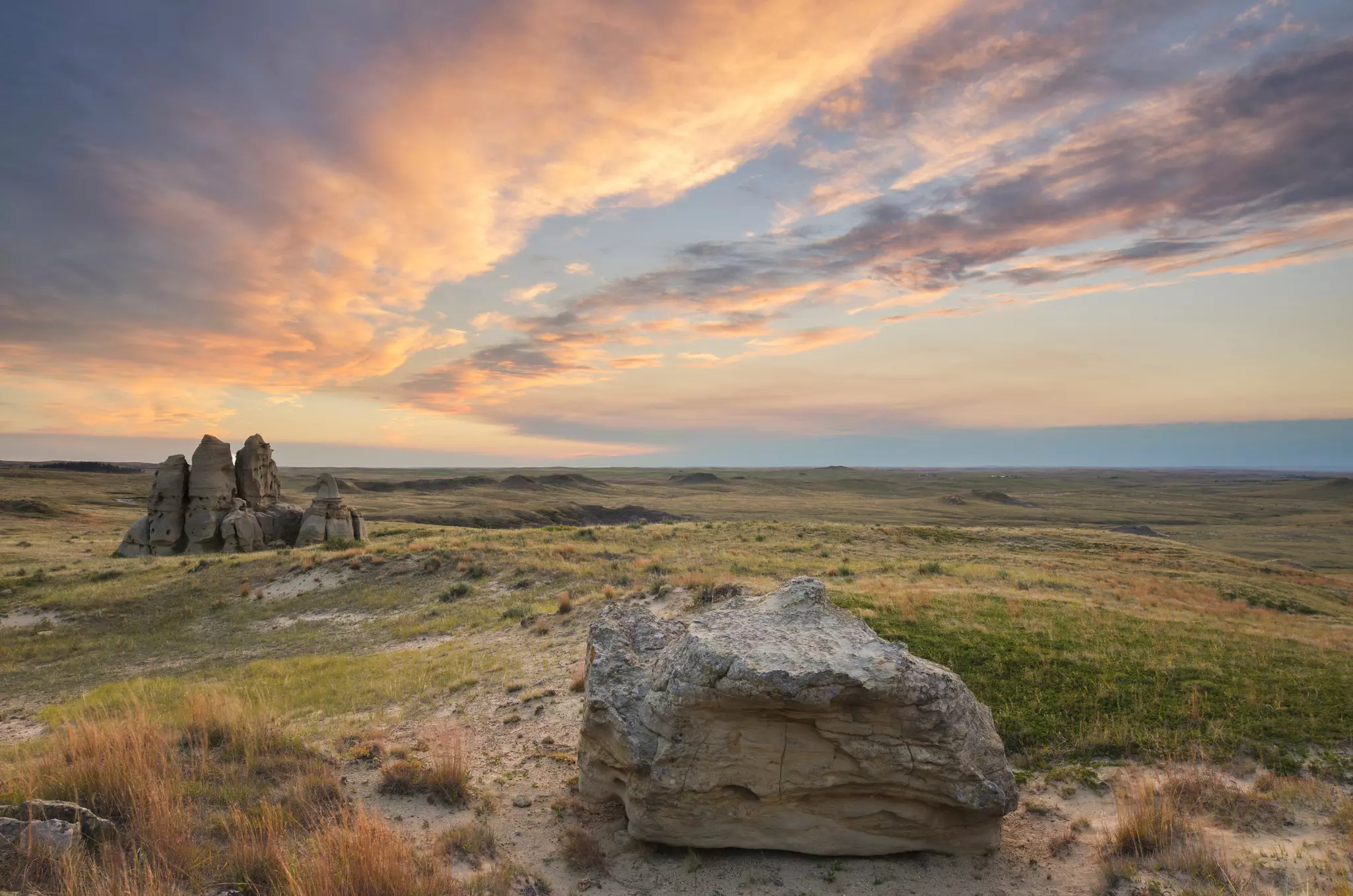 Sunset over sandstone rock formations and prairie of Medicine Rocks State Park.