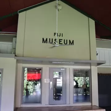 A building entrance with glass doors below a sign reading Fiji Museum.