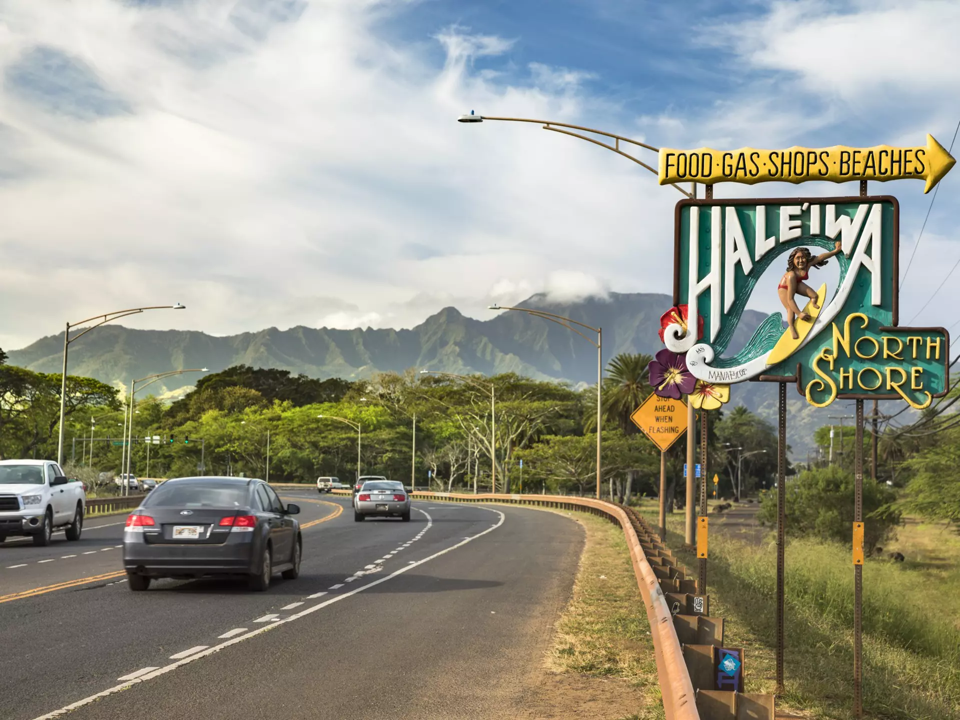 Sign for Haleiwa on the North Shore in the Waialua District.
855561212
Tourism, Vacations, Honolulu, Waikiki Beach, Exploration, Journey, USA, Shopping, Travel, Waikiki, Island, Symbol, Direction, Hawaiian Culture, Famous Place, Haleiwa, Sea, Welcome Sign, Surfboard, Freedom, Photography, Pacific Ocean, Entrance, Business Finance and Industry, Sign, Tropical Climate, Heat - Temperature, Road Trip, Beach, Greeting, Oahu, North Shore - Oahu, Travel Destinations, Horizontal, Outdoors, Pacific Islands, Hawaii Islands, Business, Surfing