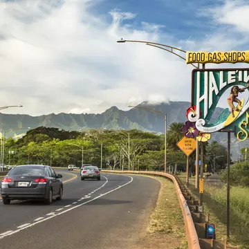 Sign for Haleiwa on the North Shore in the Waialua District.
855561212
Tourism, Vacations, Honolulu, Waikiki Beach, Exploration, Journey, USA, Shopping, Travel, Waikiki, Island, Symbol, Direction, Hawaiian Culture, Famous Place, Haleiwa, Sea, Welcome Sign, Surfboard, Freedom, Photography, Pacific Ocean, Entrance, Business Finance and Industry, Sign, Tropical Climate, Heat - Temperature, Road Trip, Beach, Greeting, Oahu, North Shore - Oahu, Travel Destinations, Horizontal, Outdoors, Pacific Islands, Hawaii Islands, Business, Surfing