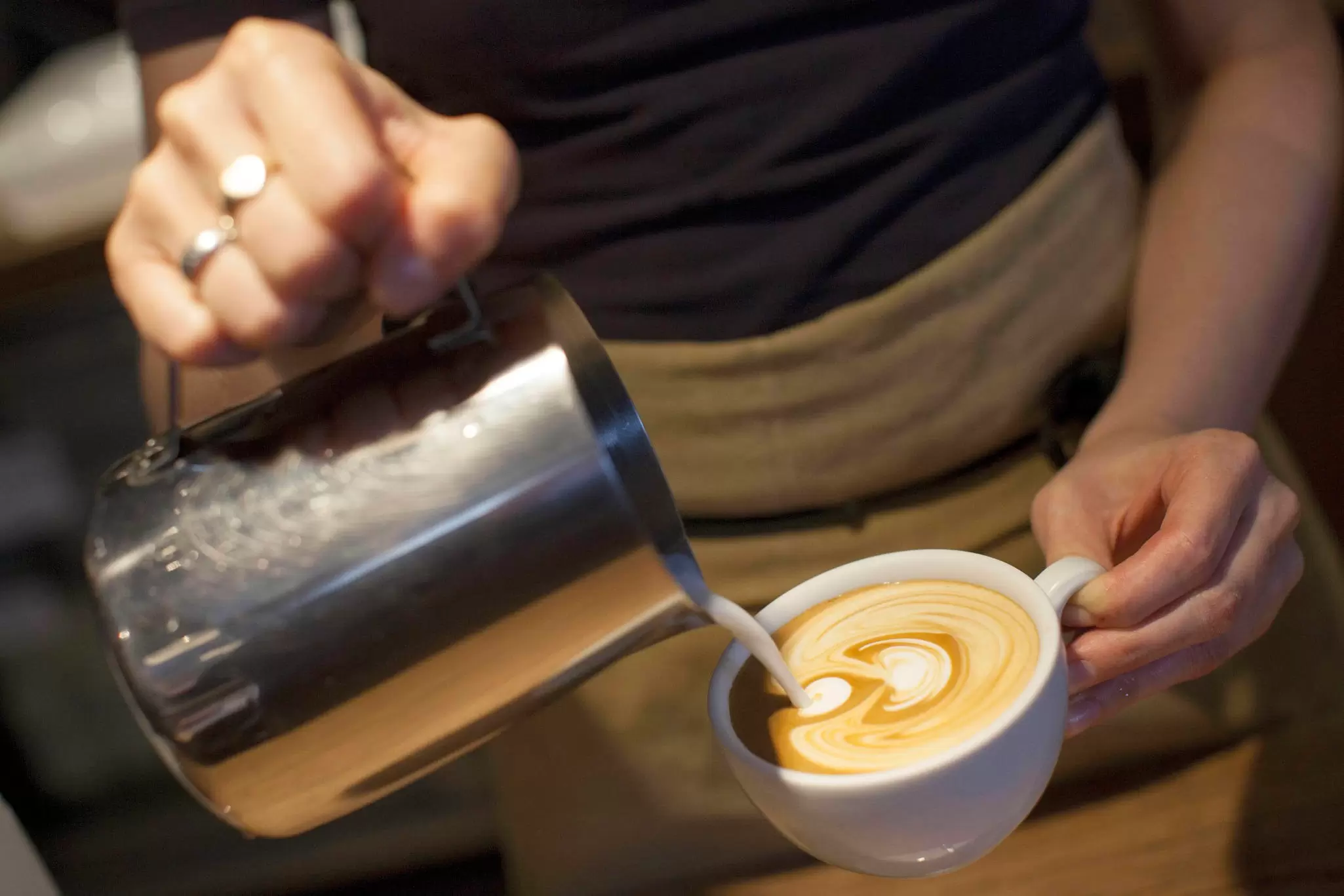 A barista pours a coffee at Monmouth Coffee Company.