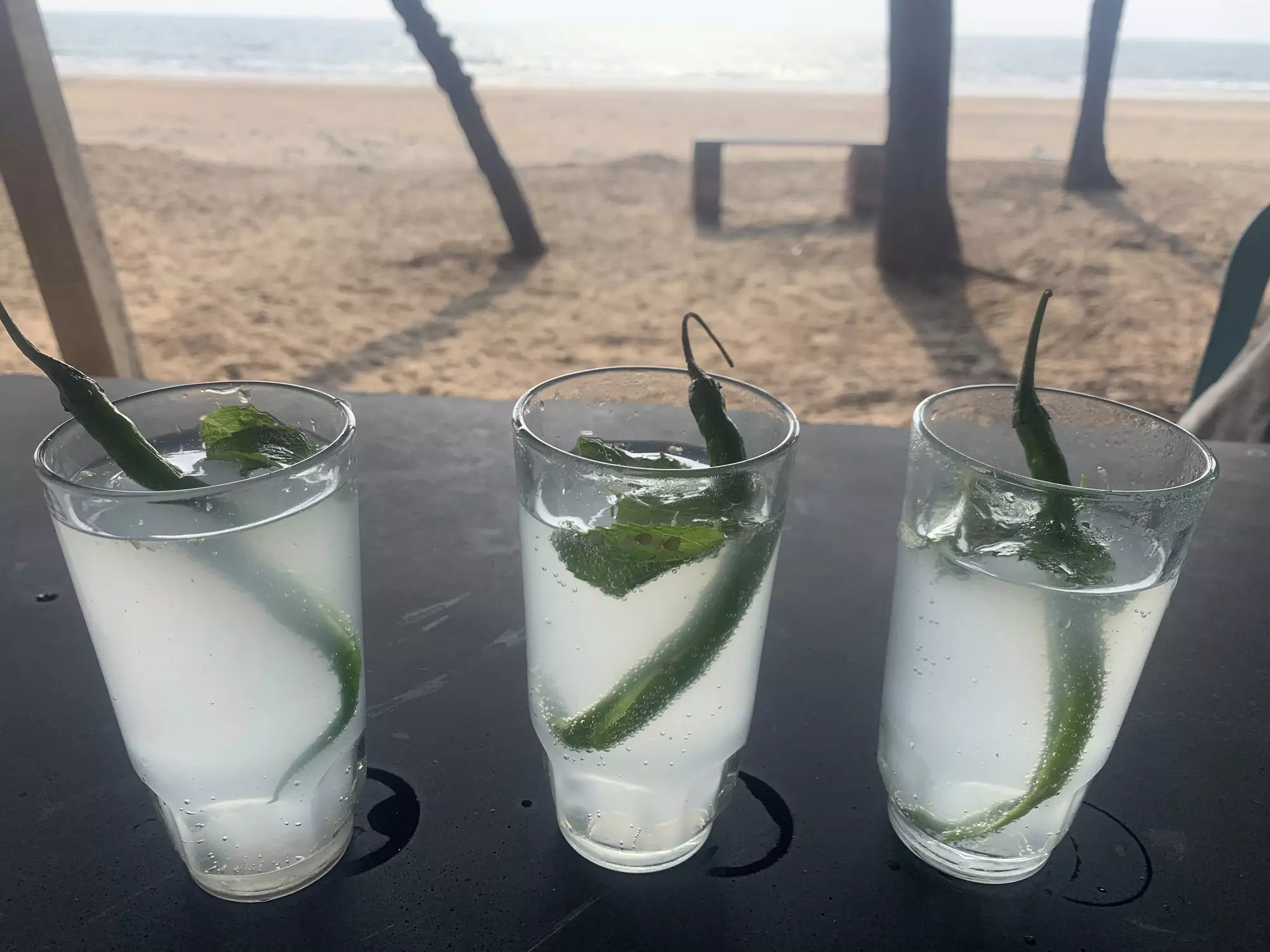 A glass of Goan feni, a traditional drink made from fermented cashew apple juice, India.