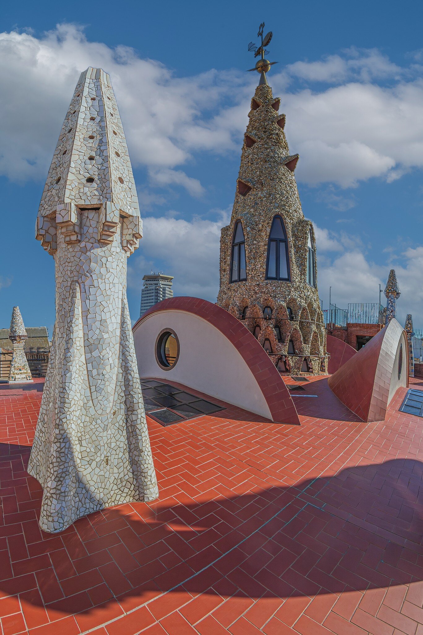 Original chimneys covered with ceramics of different colors on the roof of the Palaü Guell in Barcelona, Spain.