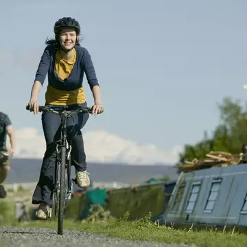 Couple cycling along canal towpath near Glasson Dock in Lancashire, England, United Kingdom