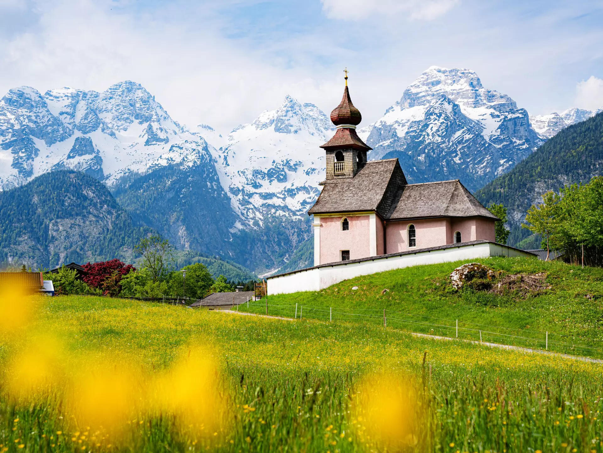 Scenic panoramic view of idyllic Auer Kircherl, an old historical chapel in the alps near the famous old village of Lofer, on a beautiful sunny day with blue sky in spring, Salzburg Land, Austria
