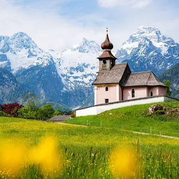 Scenic panoramic view of idyllic Auer Kircherl, an old historical chapel in the alps near the famous old village of Lofer, on a beautiful sunny day with blue sky in spring, Salzburg Land, Austria