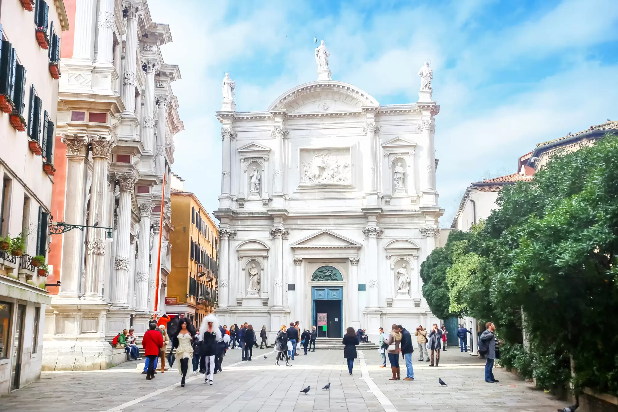 People walking in front of the Chiesa di San Rocco in Venice, Italy.
