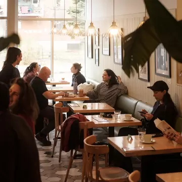 The dining room of a cafe with several tables occupied, Café Pista, Montréal, Canada