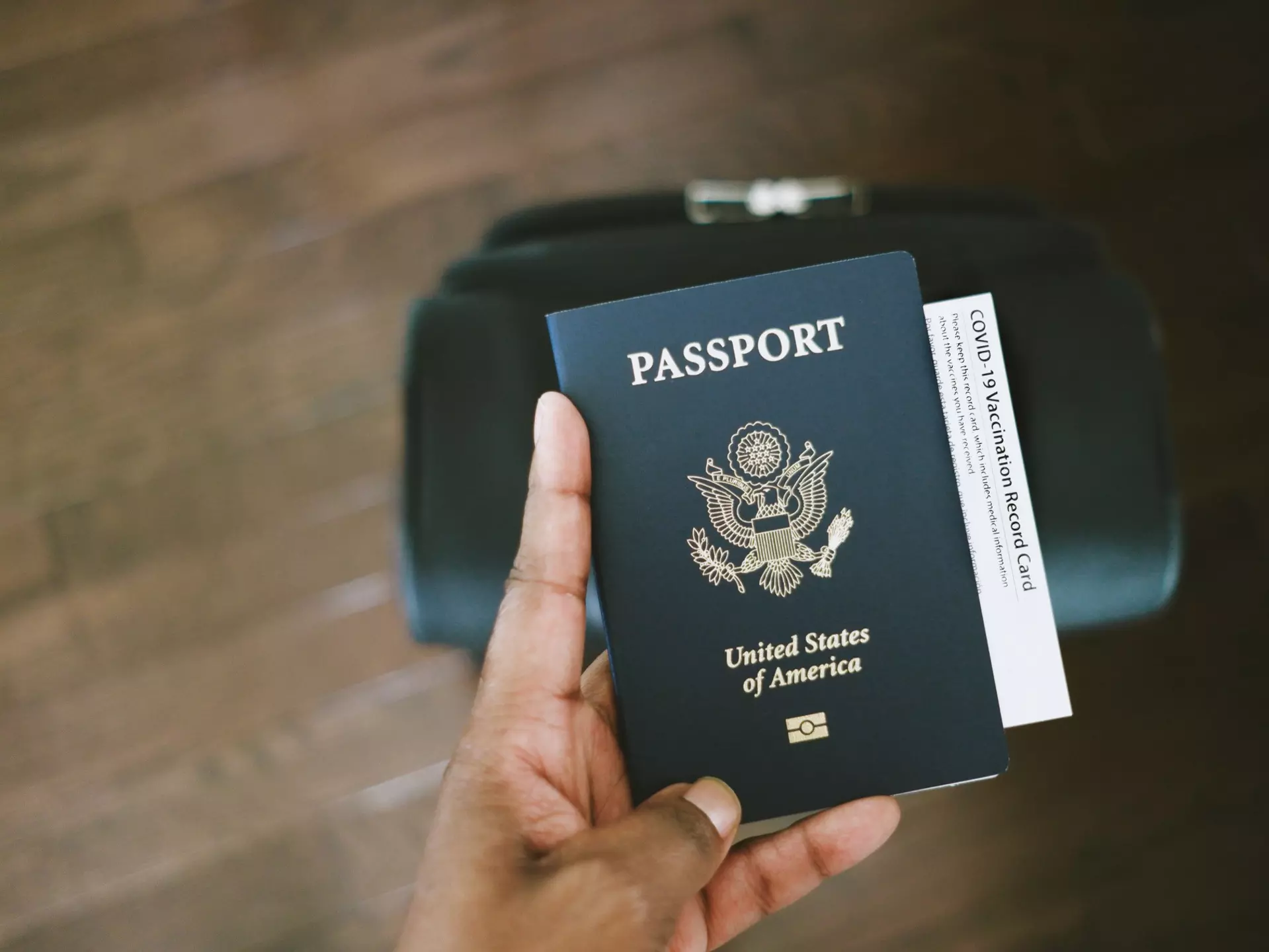 Woman Holds US Passport With COVID-19 Vaccination Card