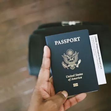 Woman Holds US Passport With COVID-19 Vaccination Card