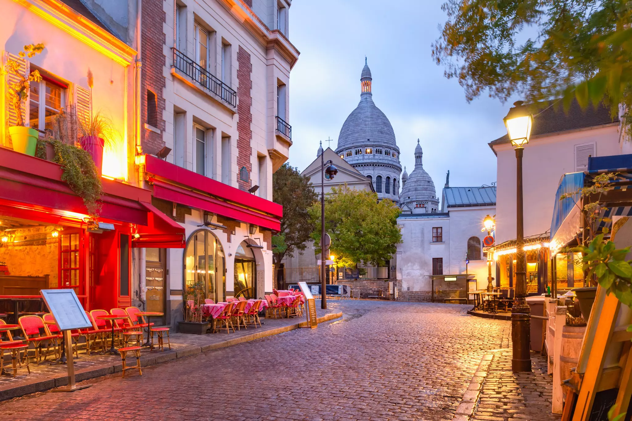 The Place du Tertre with tables of cafe and the Sacre-Coeur in the morning, quarter Montmartre in Paris