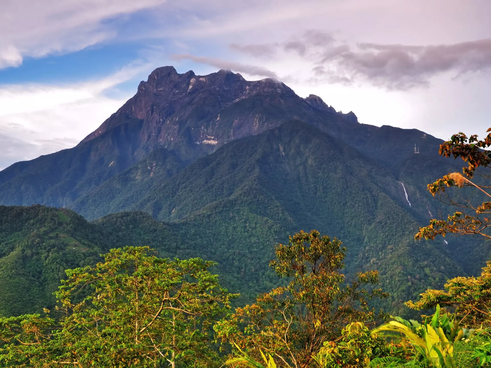 Borneo's Mount Kinabalu, a natural skyscraper with amazing biodiversity, soars into the sky.
