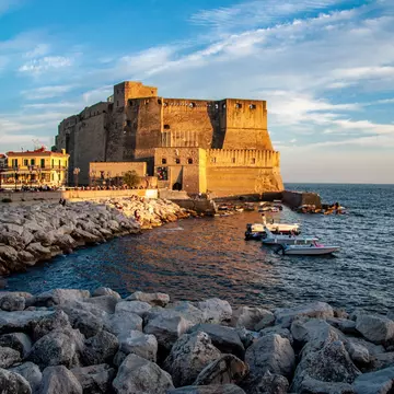 The Castel dell'Ovo photographed from the waterfront during sunset in Naples, Italy.