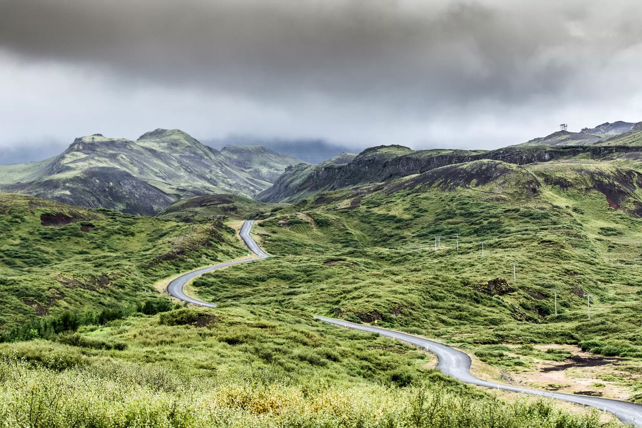 View of a road winding through Þingvellir National Park in Iceland.