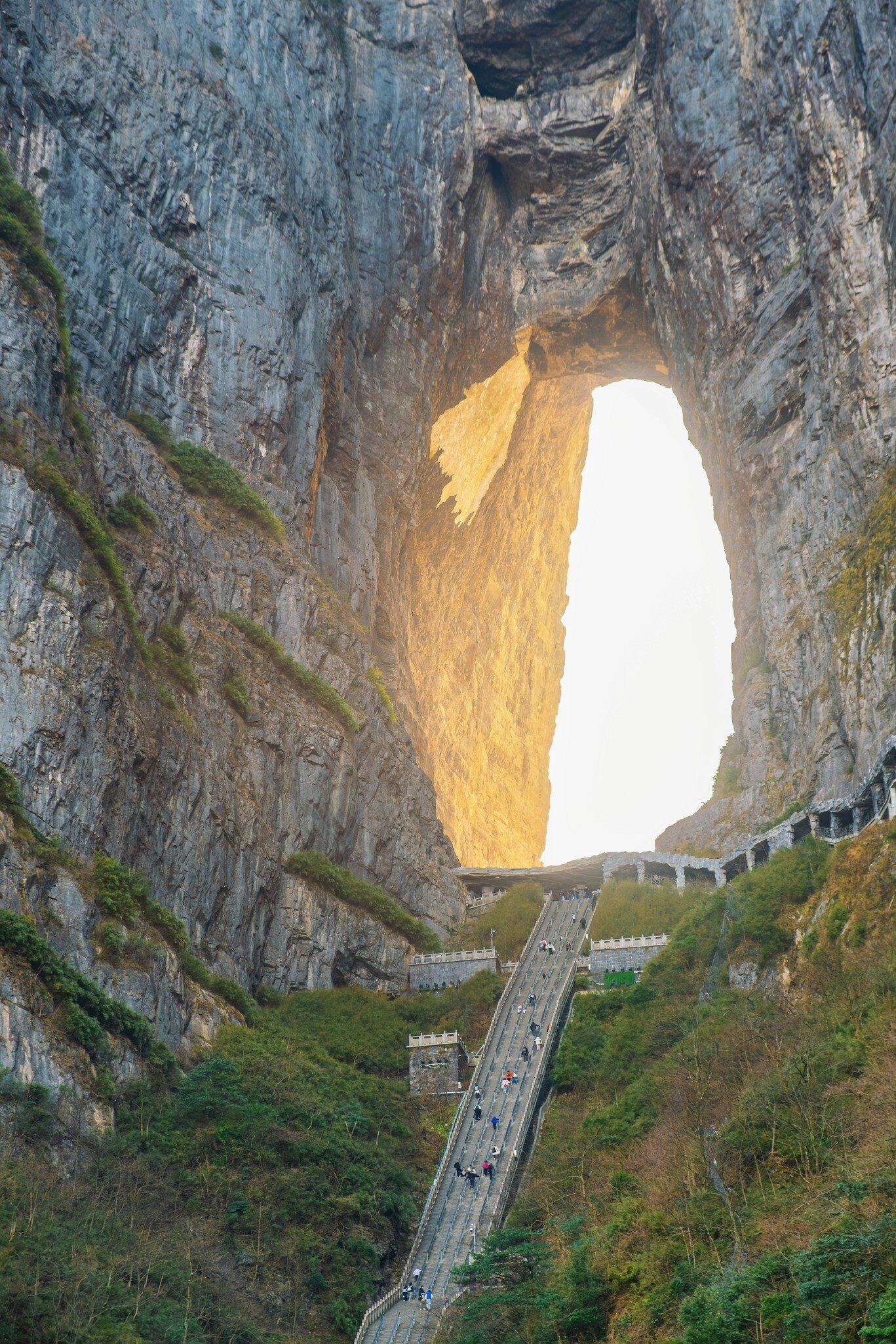 Heaven gate natural stone arch with steep staircase between massive cliffs at sunrise.in Tianmen Mountain National Park, Zhangjiajie, Hunan, China. Tianmenshan cave with 999 step, License Type: media, Download Time: 2026-09-02T17:22:06.000Z, User: LP_NZhan, Editorial: false, purchase_order: 65050 - Digital Destinations and Articles, job: App Content, client: Lonely Planet App, other: Nadine Zhan 