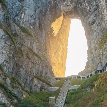 Heaven gate natural stone arch with steep staircase between massive cliffs at sunrise.in Tianmen Mountain National Park, Zhangjiajie, Hunan, China. Tianmenshan cave with 999 step, License Type: media, Download Time: 2026-09-02T17:22:06.000Z, User: LP_NZhan, Editorial: false, purchase_order: 65050 - Digital Destinations and Articles, job: App Content, client: Lonely Planet App, other: Nadine Zhan 