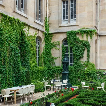 Paris, France, July 9, 2024: The vine-covered walls of the cour de la Victoire (Courtyard of the Victory) at the musée Carnavalet, with a fontaine Wallace in the background (vertical), License Type: media, Download Time: 2025-08-04T18:59:27.000Z, User: rhylton_redventures, Editorial: true, purchase_order: 65050 - Digital Destinations and Articles, job: Lonely Planet, client: wip, other: app downloads