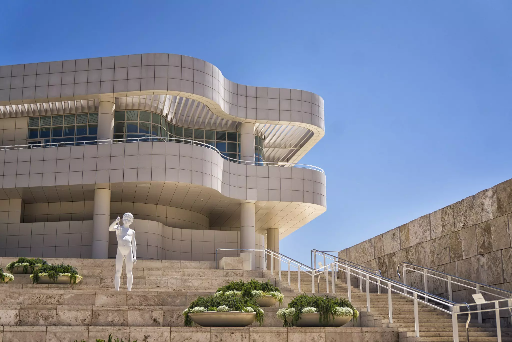 A sculpture in front of the wave-like buildings of the Getty Center in Los Angeles, California, USA.