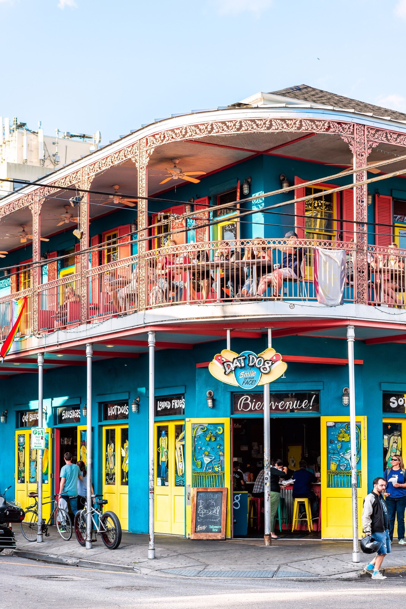 Exterior view of the brightly-colored 'Dat Dog' restaurant on Frenchmen Street in New Orleans, Louisiana.