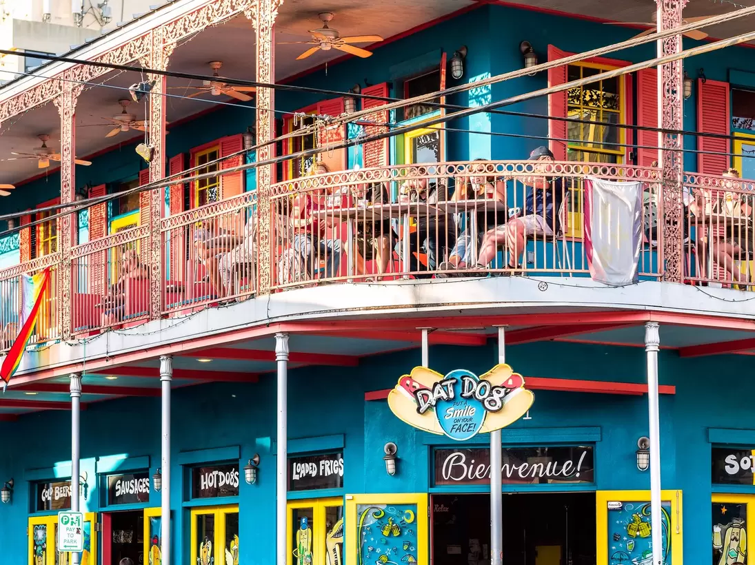 Exterior view of the brightly-colored 'Dat Dog' restaurant on Frenchmen Street in New Orleans, Louisiana.