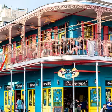 Exterior view of the brightly-colored 'Dat Dog' restaurant on Frenchmen Street in New Orleans, Louisiana.