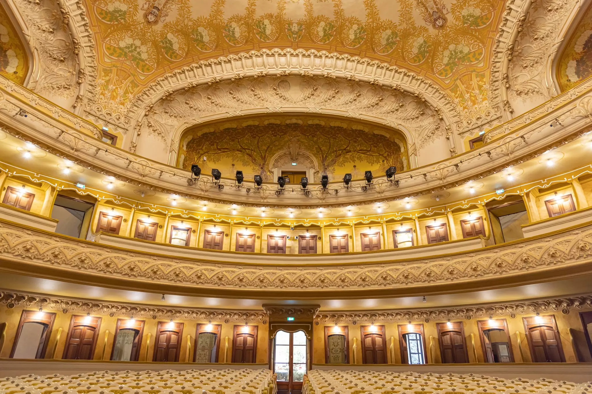 Interior of a grand opera theater in white, yellow and gold colors