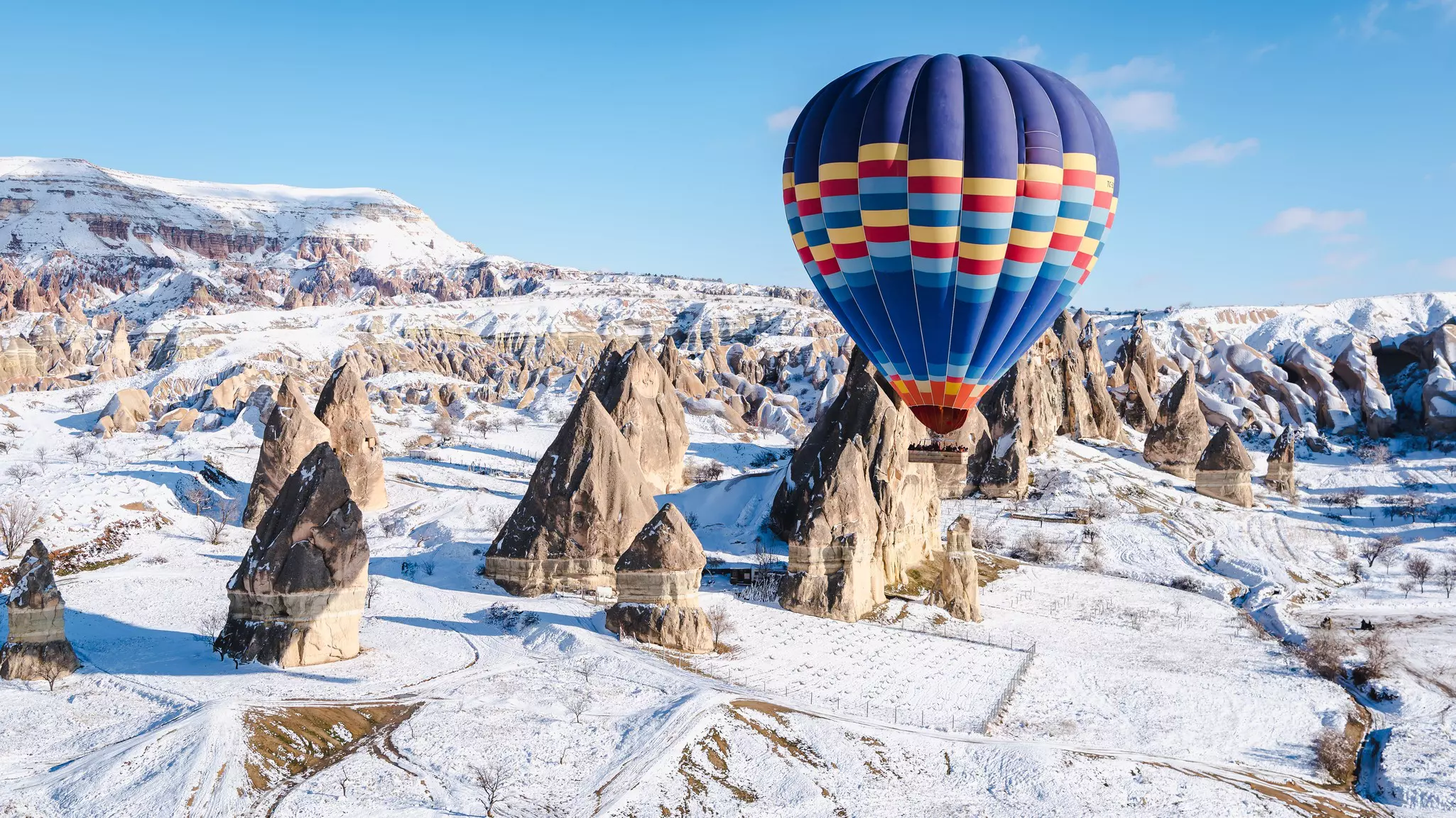 Hot-air ballooning in Cappadocia in winter. Khunhua144/Shutterstock