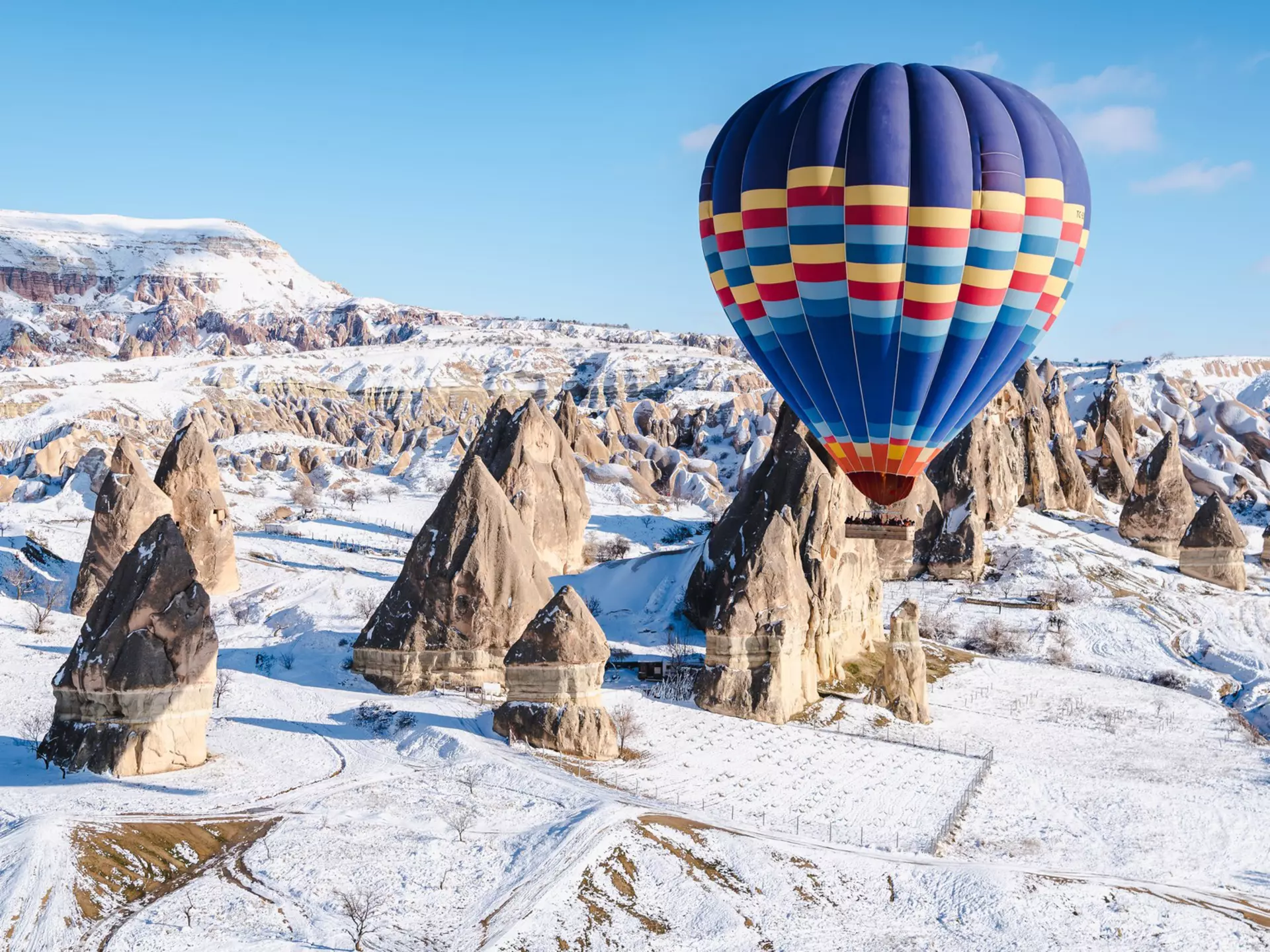 Colorful hot air balloons flying over a mountain