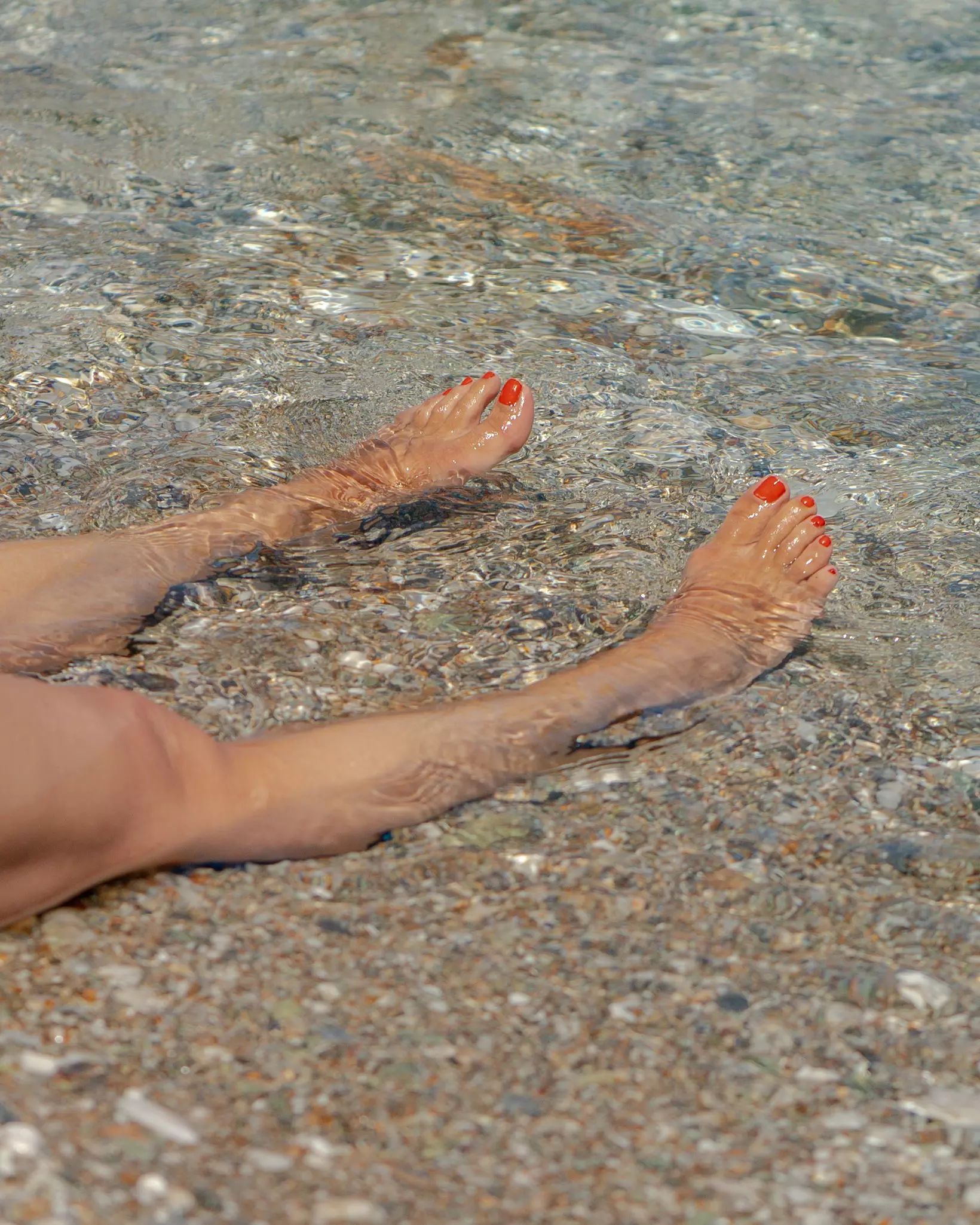 A woman's feet at Paralia Agios Nikolaos on Folegandros Island