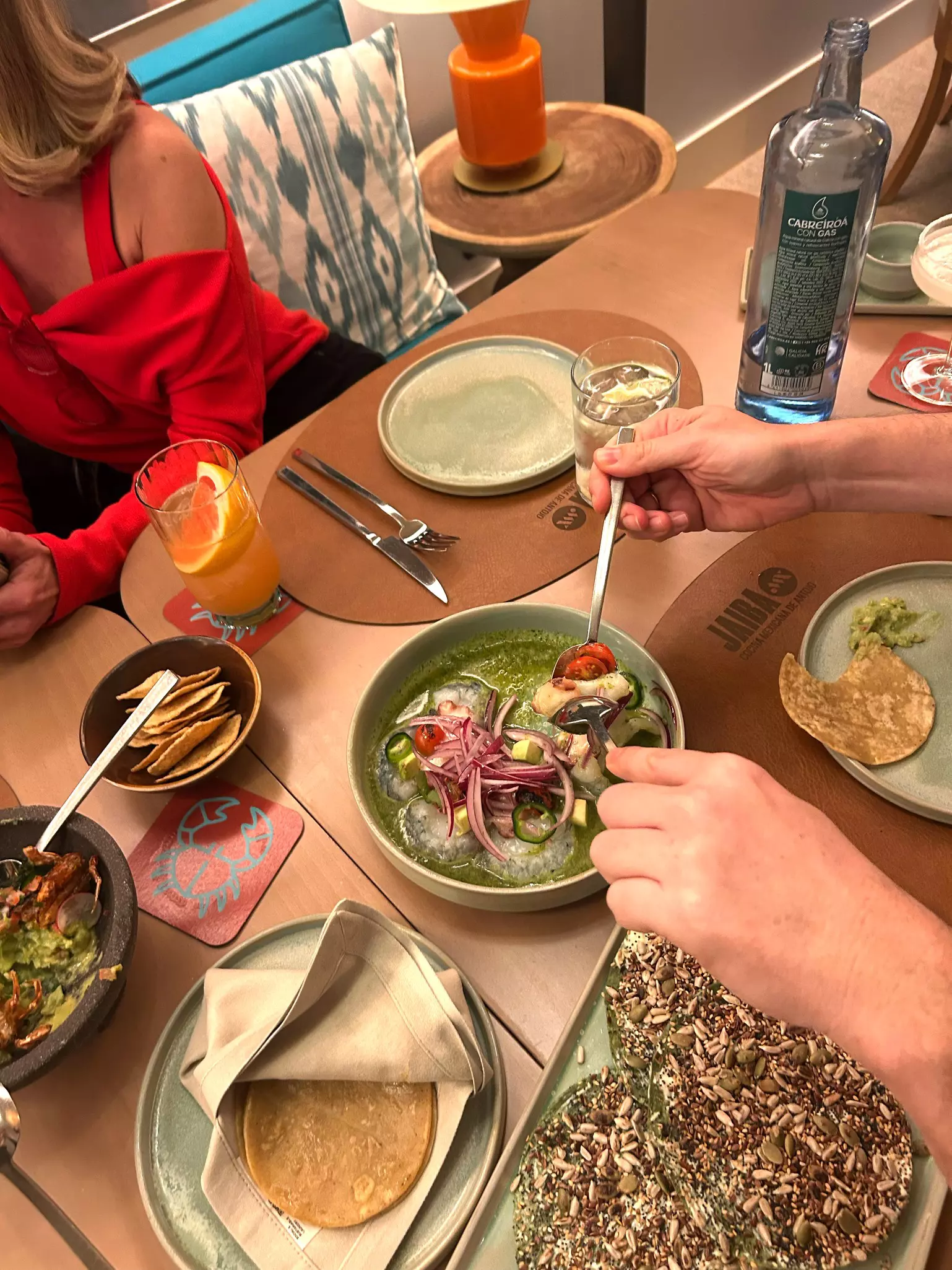 People eating Spanish foods at a table