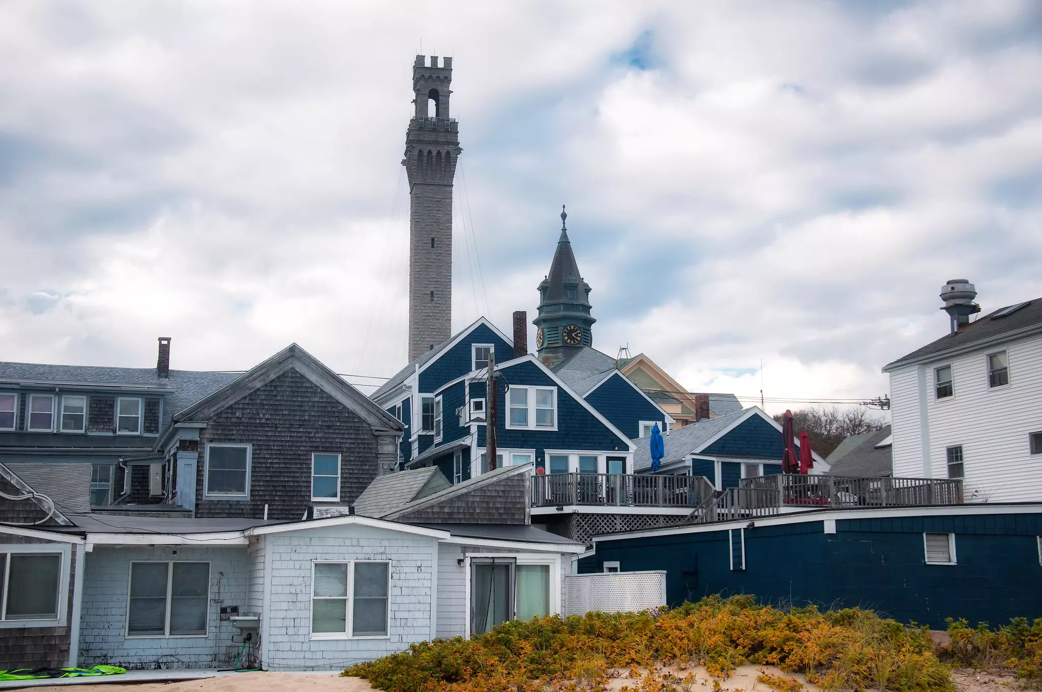 The historic landmark pilgrim monument and town hall rising above Provincetown massachusetts on a new england autumn day