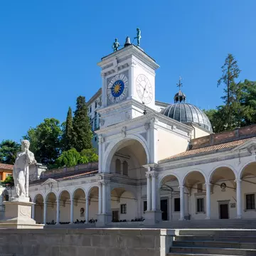 Udine, Italy; July 5 2022: Clock tower, Torre dell'Orologio, in Loggia di San Giovanni located in Piazza della Libertà with a sculpture hitting a bell above the tower.; Shutterstock ID 2275292315;