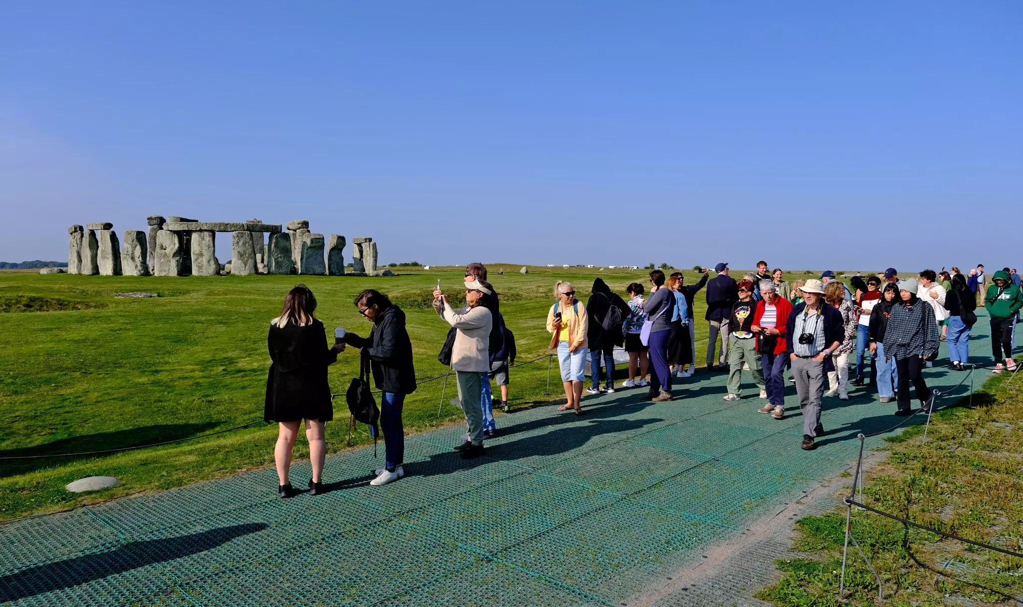 Stonehenge, Wiltshire, United Kingdom, August 30, 2024. People, visitors tourists looking at the atmospheric ancient neolithic stone circle or monument.